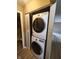 Modern stacked washer and dryer in a conveniently located laundry closet at 1614 Dayton Ave, Indianapolis, IN 46203