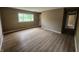 Bright living room with large window and neutral walls and laminate flooring at 1614 Dayton Ave, Indianapolis, IN 46203