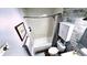 Bright bathroom featuring a tub with shower, toilet, and vanity with decorative wood paneled accent wall at 170 Briar Hill Dr, Whiteland, IN 46184
