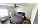 Cozy bedroom with window, ceiling fan, neutral tones, and carpet with bed, dresser, and nightstand at 170 Briar Hill Dr, Whiteland, IN 46184