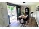 Stylish dining room features modern light fixtures and sliding glass doors to the backyard at 170 Briar Hill Dr, Whiteland, IN 46184