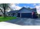 Charming single-story home with navy siding, black brick accents, a two-car garage, and neatly maintained lawn at 170 Briar Hill Dr, Whiteland, IN 46184