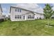A well-manicured backyard with a patio and view of the home's siding and windows at 19442 Honeylocust Glen, Noblesville, IN 46062