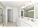 Bright bathroom featuring double sinks with quartz countertops, a glass-enclosed shower, and neutral walls at 19442 Honeylocust Glen, Noblesville, IN 46062