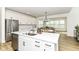 Modern kitchen featuring stainless steel appliances, white cabinets, and an eat-in island at 19442 Honeylocust Glen, Noblesville, IN 46062