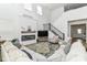 Spacious living room with a fireplace, modern staircase, and large windows for ample lighting at 19442 Honeylocust Glen, Noblesville, IN 46062
