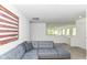 Spacious living room with a comfortable sectional, neutral walls and flooring, and ample natural light at 19442 Honeylocust Glen, Noblesville, IN 46062