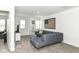 Cozy living room features a comfortable grey sectional couch and an American flag art piece at 19442 Honeylocust Glen, Noblesville, IN 46062