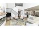 Open-concept living room with modern furniture, a staircase, and seamless flow to the kitchen at 19442 Honeylocust Glen, Noblesville, IN 46062