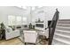 Bright and open living room with a cozy fireplace and comfortable seating arrangement at 19442 Honeylocust Glen, Noblesville, IN 46062