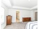 Open bedroom featuring neutral walls and carpeting with wood dressers and doorway to bathroom at 19442 Honeylocust Glen, Noblesville, IN 46062