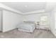 Spacious bedroom featuring a tray ceiling, neutral walls, carpeted floor, and ample natural light at 19442 Honeylocust Glen, Noblesville, IN 46062