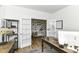 Bright home office with french doors leading to another room with a collection of photos on the wall at 19442 Honeylocust Glen, Noblesville, IN 46062