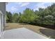 Backyard view from concrete patio showcasing mature trees with view of sky and clouds at 19570 Forsythe Dr, Noblesville, IN 46060