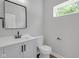 Elegant powder room featuring a sleek vanity, black accents, and natural light at 19570 Forsythe Dr, Noblesville, IN 46060