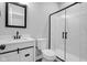 This modern bathroom features a white vanity, sleek fixtures, and a glass shower with black trim at 19570 Forsythe Dr, Noblesville, IN 46060
