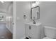 Neutral powder room with black hardware and a modern vanity and mirror at 19570 Forsythe Dr, Noblesville, IN 46060