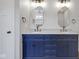 Primary bathroom featuring a blue double vanity and elegant gold fixtures at 19570 Forsythe Dr, Noblesville, IN 46060
