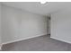 A gray bedroom features neutral carpet, a door, white trim, and a overhead light at 19570 Forsythe Dr, Noblesville, IN 46060