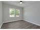 Bright bedroom with ample natural light from two windows and modern wood-look flooring at 19570 Forsythe Dr, Noblesville, IN 46060