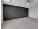 An empty bedroom features an attractive black accent wall and tray ceiling at 19570 Forsythe Dr, Noblesville, IN 46060