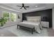 Staged bedroom featuring a stylish accent wall, tray ceiling, and neutral decor at 19570 Forsythe Dr, Noblesville, IN 46060
