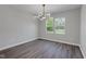 Bright dining room showcasing sleek floors, a modern light fixture, and dual windows at 19570 Forsythe Dr, Noblesville, IN 46060