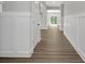 Well-lit hallway with wood floors and modern trim, leading to various parts of the house at 19570 Forsythe Dr, Noblesville, IN 46060
