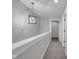 Upstairs hallway featuring neutral paint, plush carpeting, and modern light fixture at 19570 Forsythe Dr, Noblesville, IN 46060