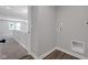 Hallway featuring neutral paint and view of laundry room with utility hookups at 19570 Forsythe Dr, Noblesville, IN 46060