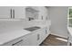 Close up of the kitchen with white cabinetry, subway tile backsplash, and modern black hardware at 19570 Forsythe Dr, Noblesville, IN 46060