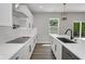 Contemporary kitchen with white cabinets, quartz countertops, stainless steel appliances, and a black cooktop on the counter at 19570 Forsythe Dr, Noblesville, IN 46060