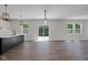Open-concept living space with wood floors, recessed lighting, and large windows at 19570 Forsythe Dr, Noblesville, IN 46060