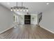 Bright living area with wood floors, modern fireplace, and natural light from large windows at 19570 Forsythe Dr, Noblesville, IN 46060