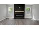 Contemporary living room with sleek fireplace, wood floors, and bright natural light at 19570 Forsythe Dr, Noblesville, IN 46060