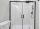 The glass enclosed shower features a rain shower head and matte black hardware at 19570 Forsythe Dr, Noblesville, IN 46060