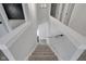 Carpeted staircase with white railing leads to the lower level at 19570 Forsythe Dr, Noblesville, IN 46060