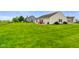 Large backyard with well-kept lawn, outdoor patio area, and ample space for recreation and enjoyment at 204 Oakview Dr, Mooresville, IN 46158