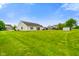 Large backyard with green grass, a shed, a patio set; great for outdoor activities or relaxing at 204 Oakview Dr, Mooresville, IN 46158