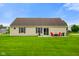 Expansive backyard with lush green grass, an outdoor patio with seating, and a well-maintained lawn at 204 Oakview Dr, Mooresville, IN 46158