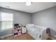 Comfortable bedroom with a neutral color scheme, a window with blinds, and a shelf for personal items at 204 Oakview Dr, Mooresville, IN 46158
