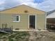 Exterior shot of the back of the house showing the siding, door, and window at 2146 Gent Ave, Indianapolis, IN 46202