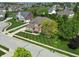 Aerial view of home with manicured lawn, mature trees and landscaping, and a three car garage at 2219 Stone Manor Ct, Avon, IN 46123