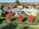 Aerial view of home with fenced yard, beautiful fall foliage, and outdoor play equipment at 2219 Stone Manor Ct, Avon, IN 46123