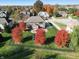 Aerial view of home with fenced yard, beautiful fall foliage, and outdoor play equipment at 2219 Stone Manor Ct, Avon, IN 46123