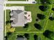 Aerial view of property with manicured lawn, fenced yard, patio, play area, and mature trees at 2219 Stone Manor Ct, Avon, IN 46123