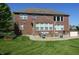 Spacious backyard featuring a brick home, patio, fire pit, and well-maintained lawn at 2219 Stone Manor Ct, Avon, IN 46123