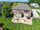 Aerial view of backyard patio with hot tub, outdoor kitchen, and comfortable seating area at 2219 Stone Manor Ct, Avon, IN 46123
