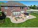 Aerial view of backyard patio with hot tub, outdoor kitchen, and comfortable seating area at 2219 Stone Manor Ct, Avon, IN 46123