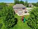 Aerial view of backyard with playground, patio, hot tub, and outdoor kitchen at 2219 Stone Manor Ct, Avon, IN 46123